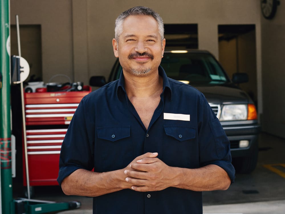 The owner of Stanley's Auto Repair in the service bay